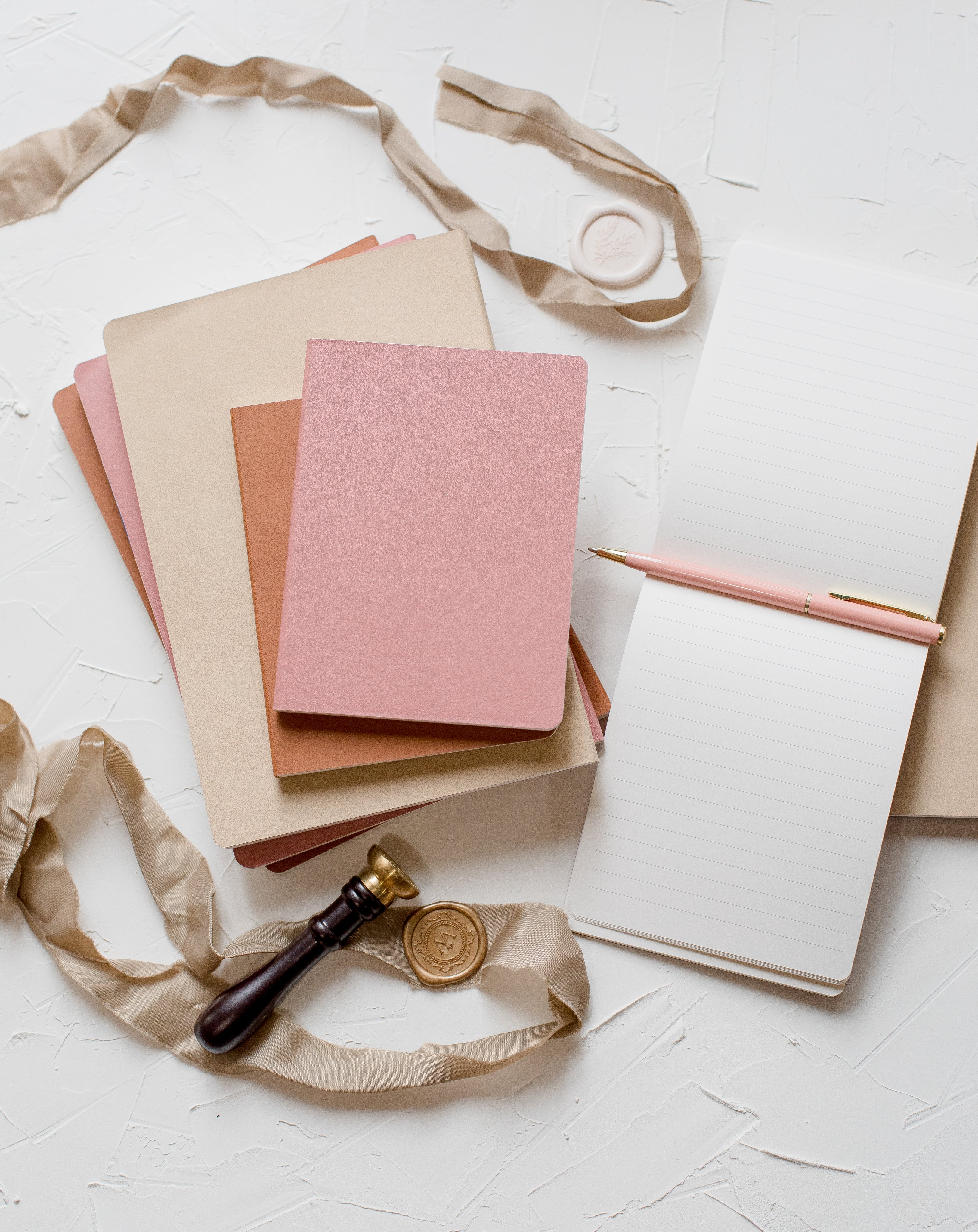 flatlay-of-notebooks-a-ribbon-and-a-wax-seal.jpg